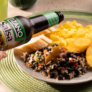 Salsa Lizano poured over rice and beans